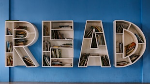 floating book shelf spelling out the word "READ"