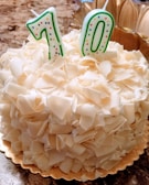 Close-up of a beautifully decorated birthday cake with '70' in sparkling candles