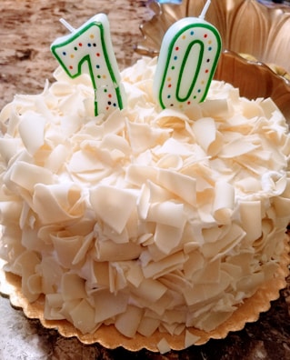 Close-up of a beautifully decorated birthday cake with '70' in sparkling candles