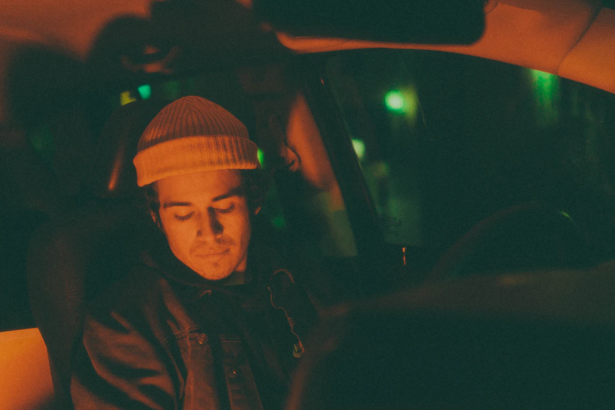 A driver nodding off at the wheel at night