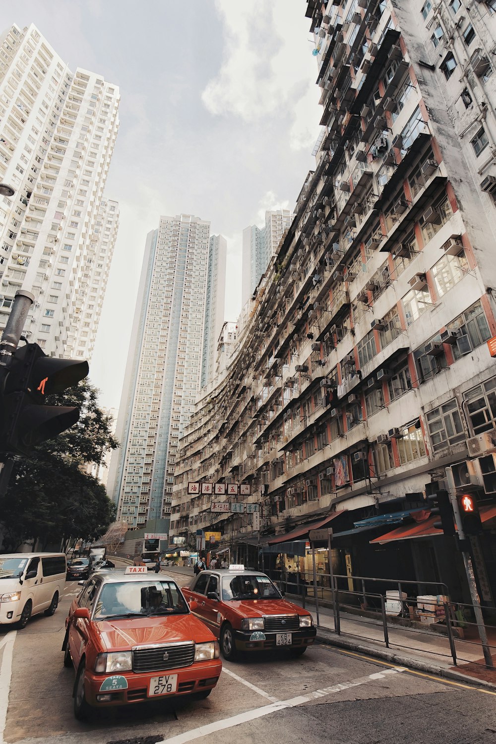 cars on road near high rise buildings during daytime