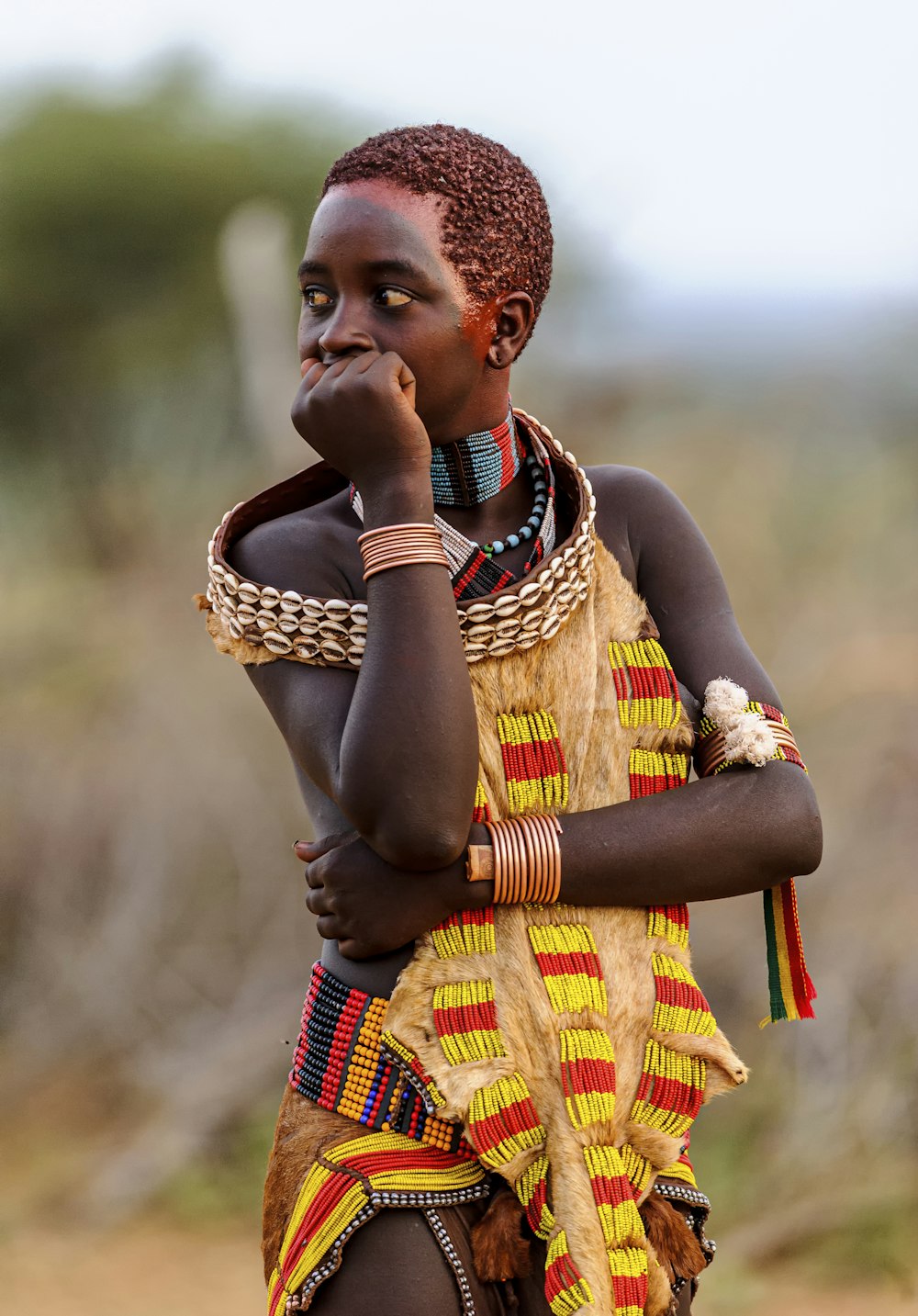 a young woman in a colorful dress talking on a cell phone