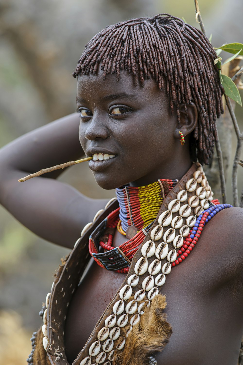 a woman with a stick in her mouth