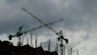 a large crane on top of a building under a cloudy sky