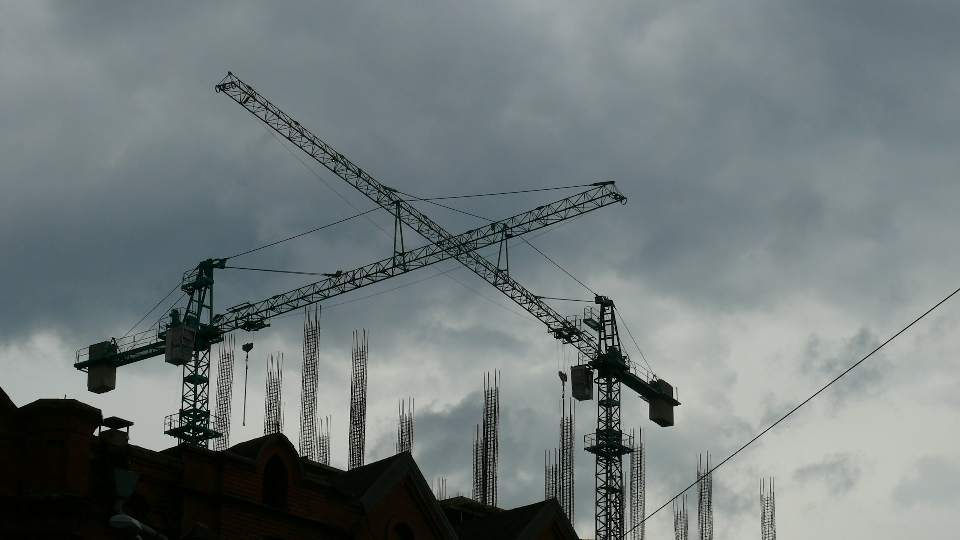a large crane on top of a building under a cloudy sky