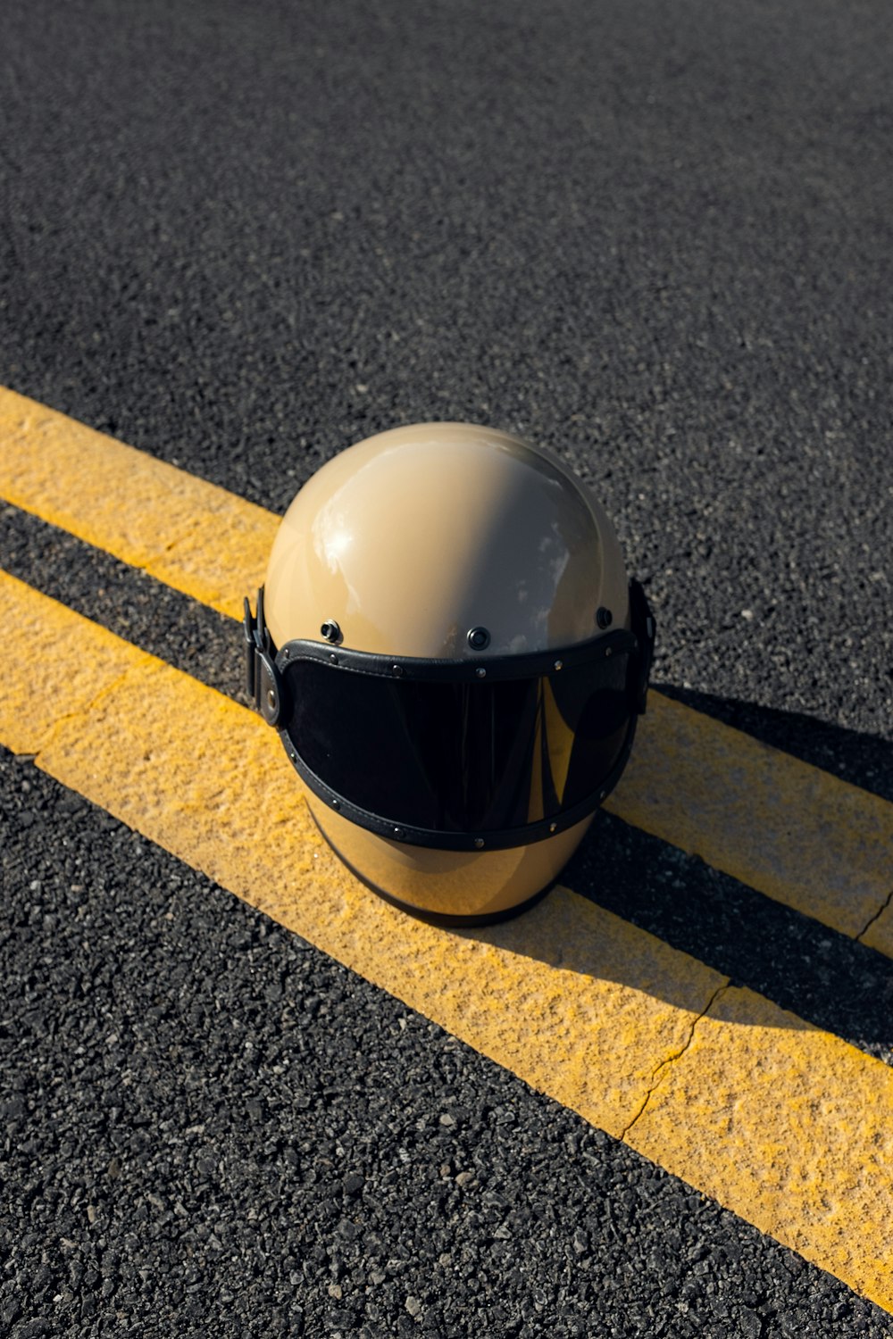 white helmet on grey concrete pavement