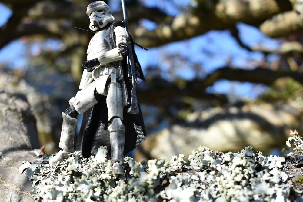 a figurine of a man holding a sword on top of a rock