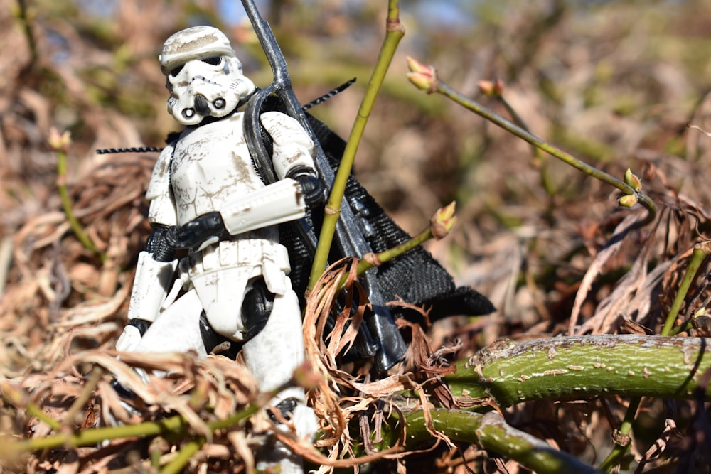a star wars action figure standing in a field