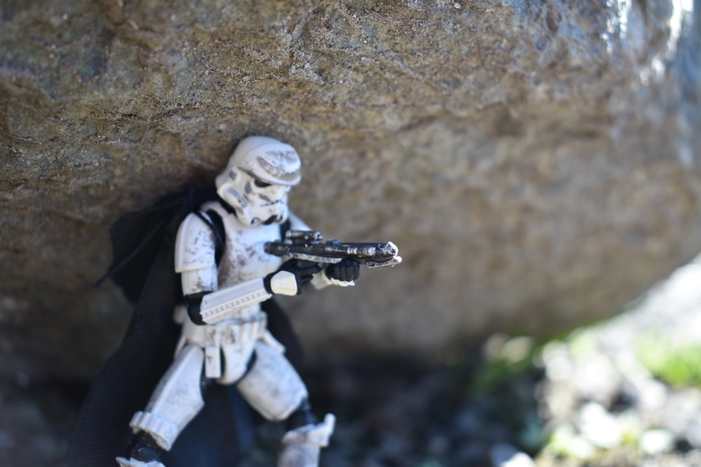 a star wars action figure holding a gun