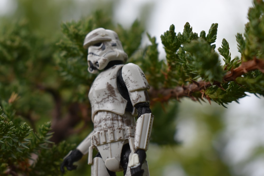 a star wars figurine hanging from a tree branch