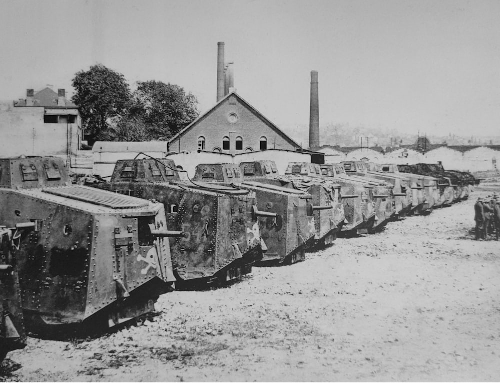 a row of tanks sitting in front of a building