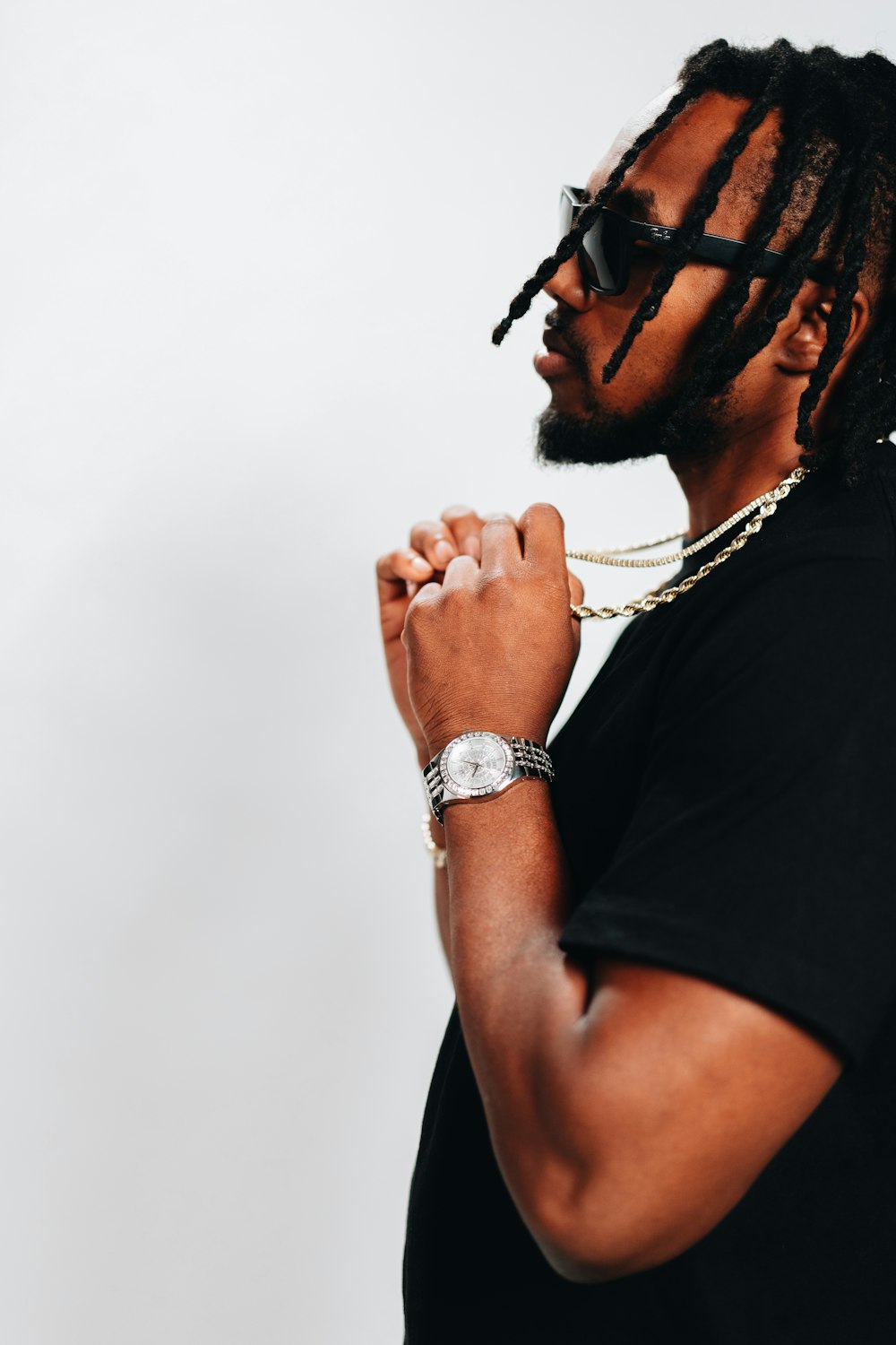 a man with dreadlocks and a watch on his wrist