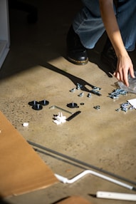person holding silver and black gemstone accessory