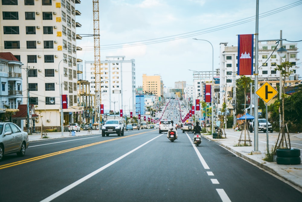 a city street with a few cars driving down it