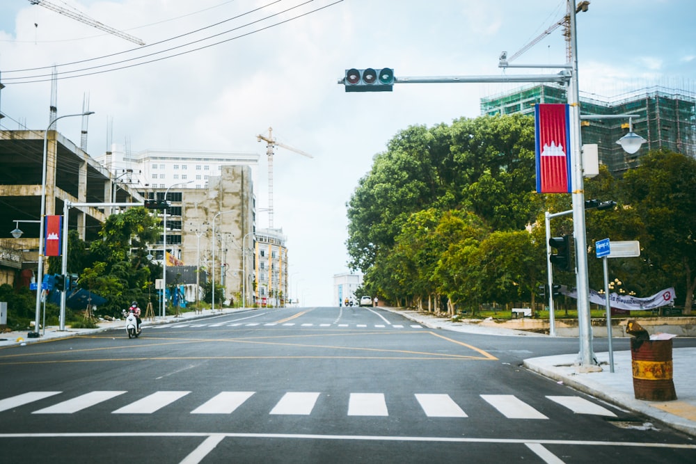 a city street with a traffic light and buildings in the background