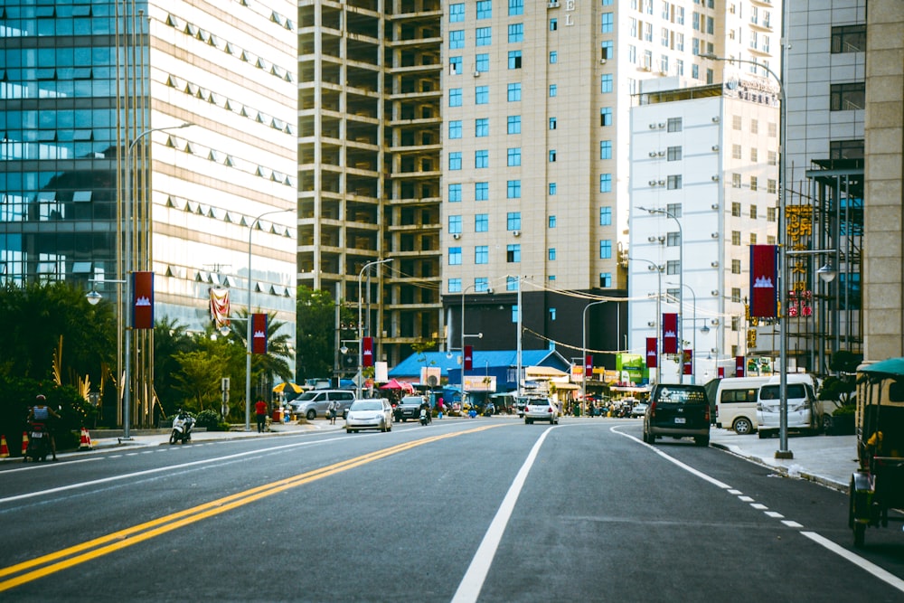 a city street filled with lots of traffic next to tall buildings