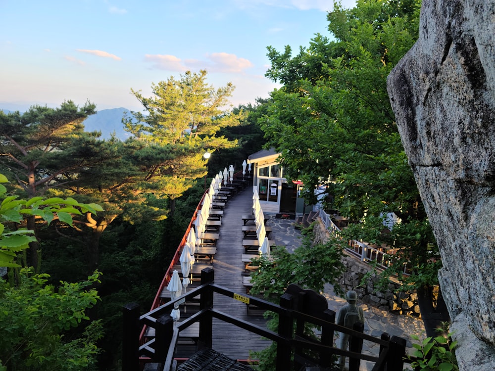 a view of a wooden walkway with benches on the side of it