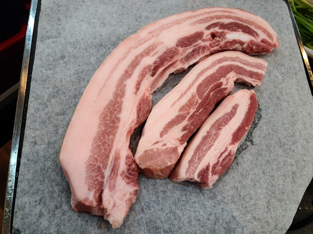 a pile of raw meat sitting on top of a cutting board