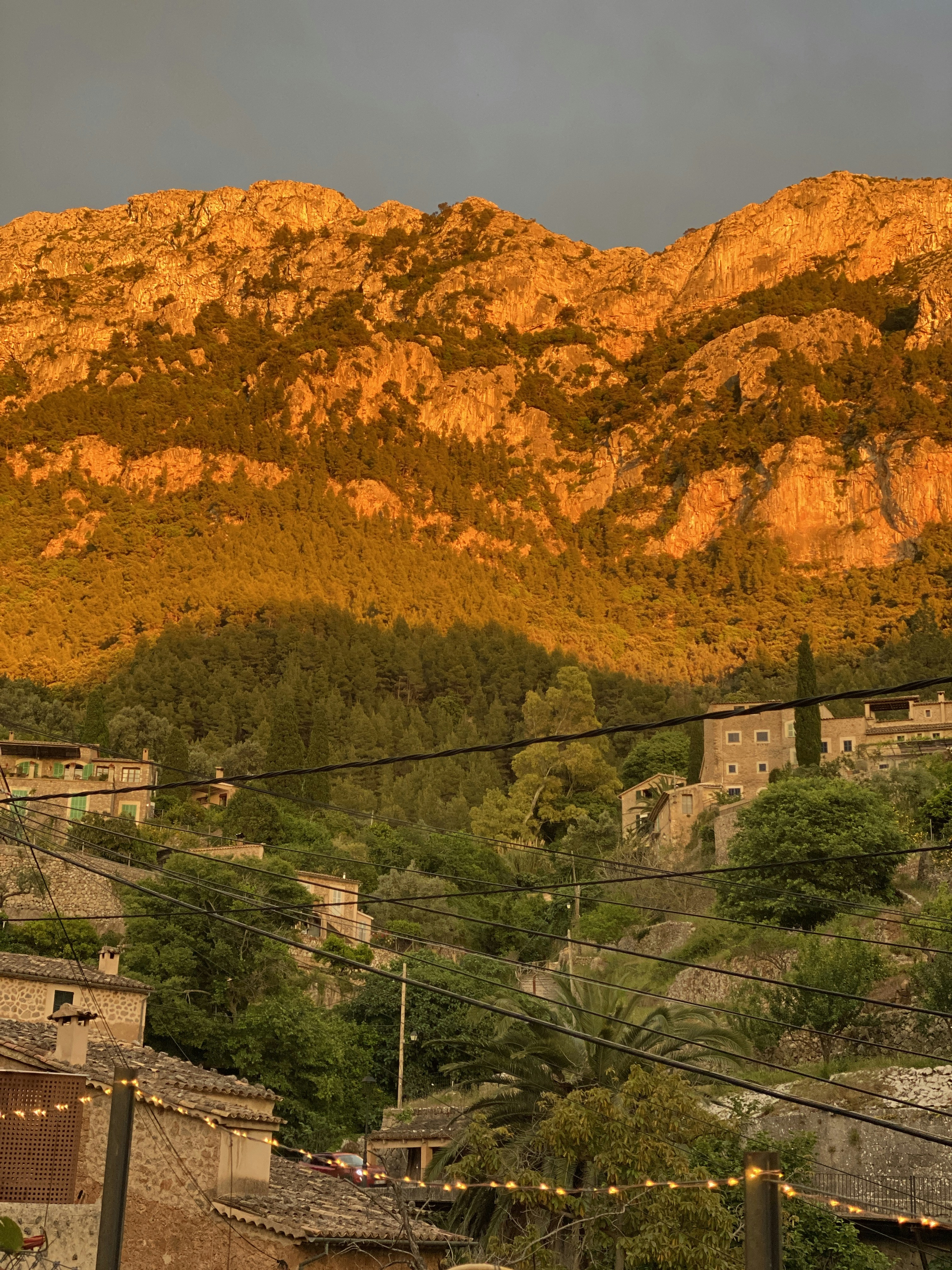 a view of a mountain with a village in the foreground