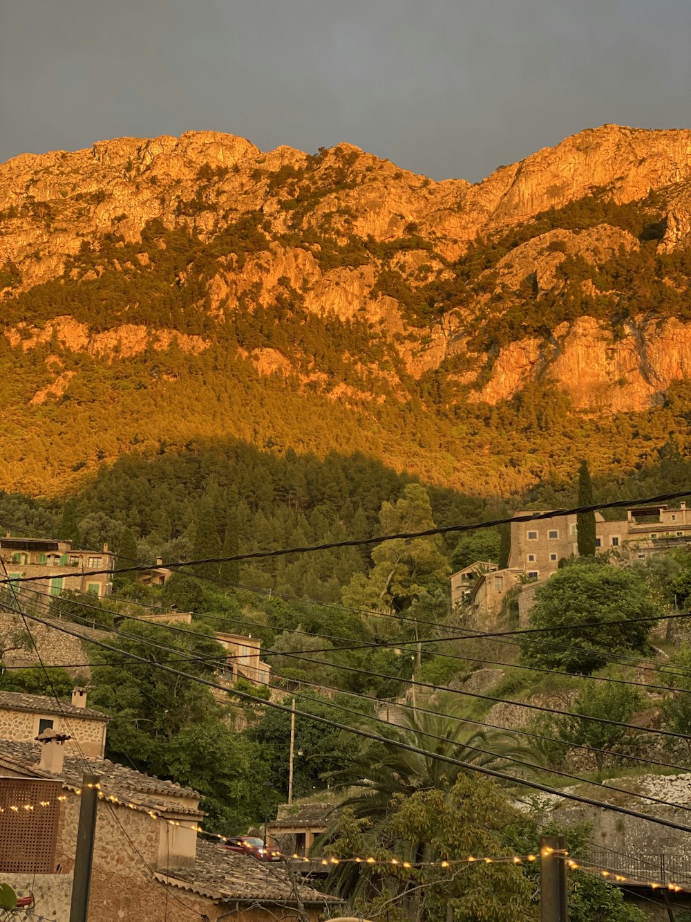 a view of a mountain with a village in the foreground