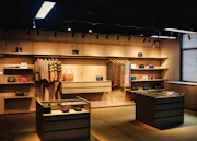 a room with a lot of shelves and a lot of purses