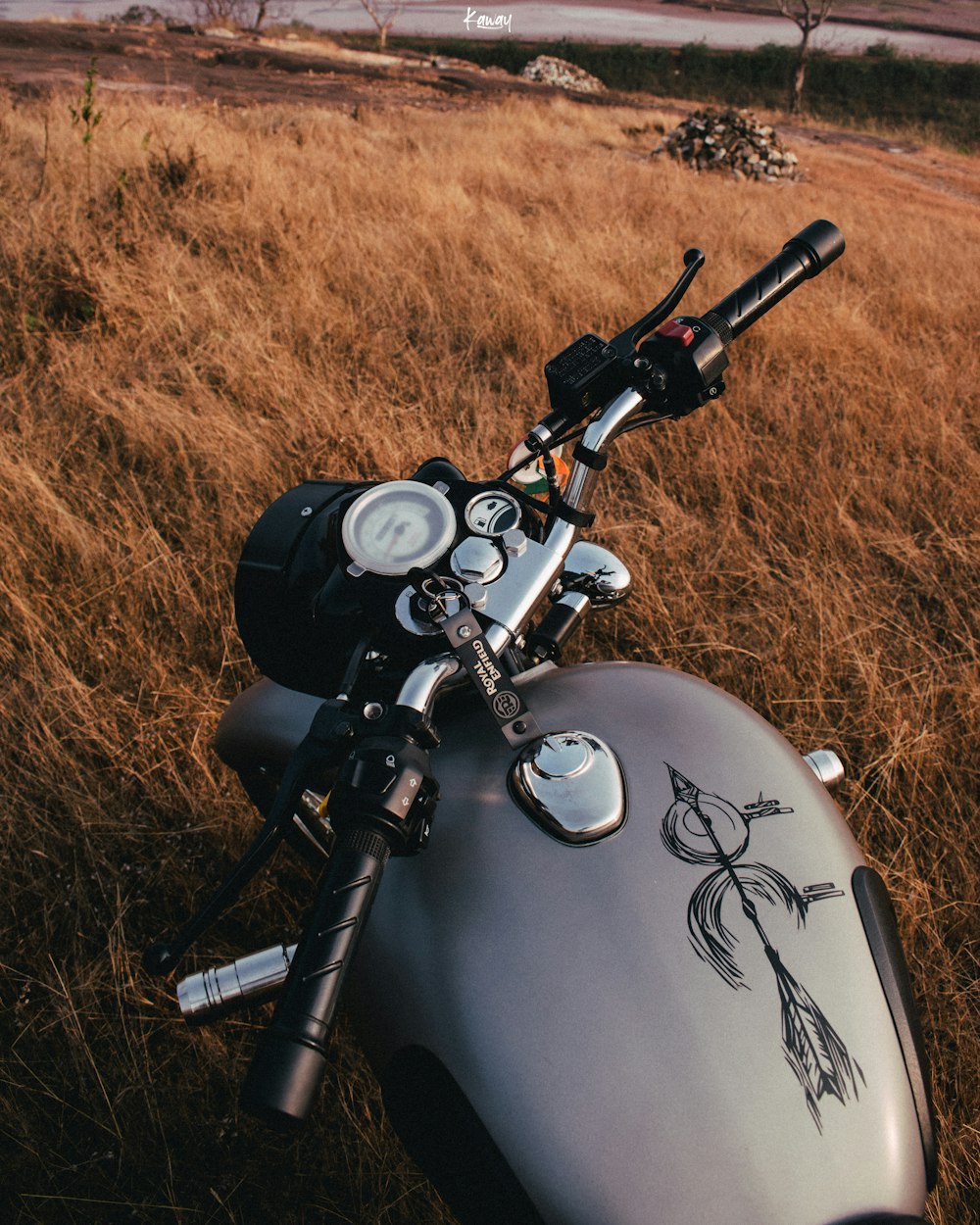 a motorcycle parked in a field of tall grass