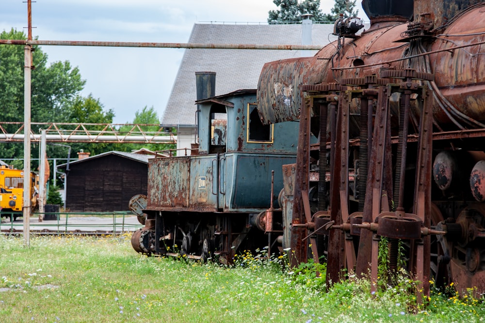 an old rusty train sitting on the tracks
