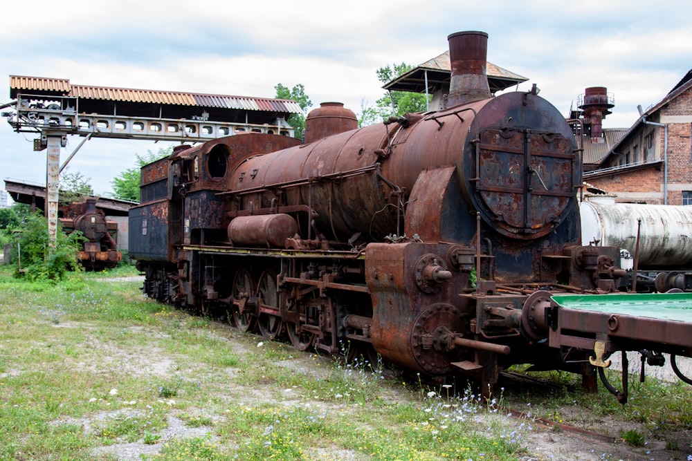 an old rusty train sitting on the tracks