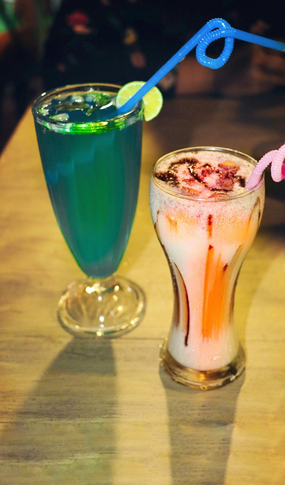 a couple of drinks sitting on top of a wooden table