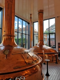 a couple of large metal tanks sitting inside of a building