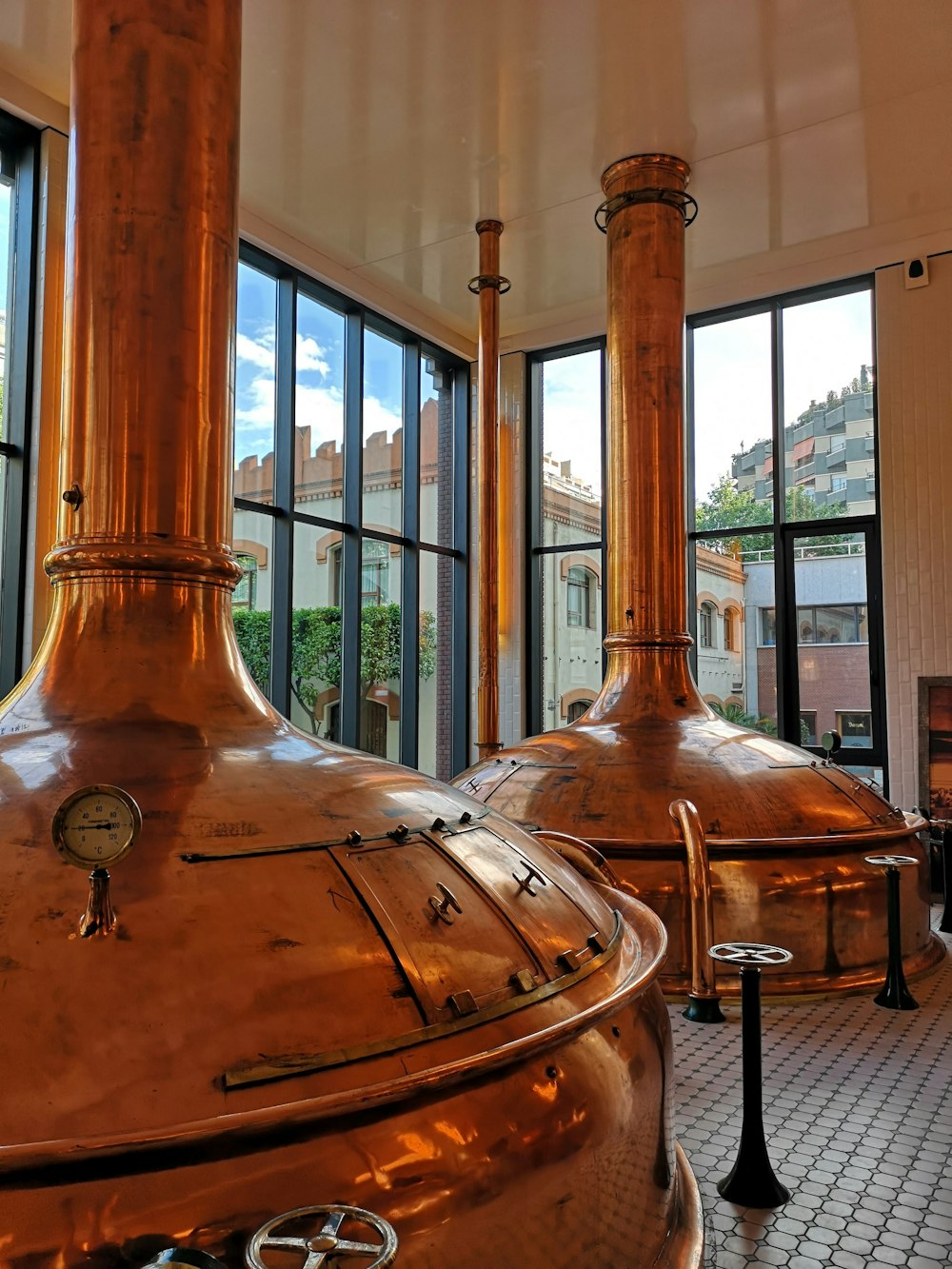 a couple of large metal tanks sitting inside of a building