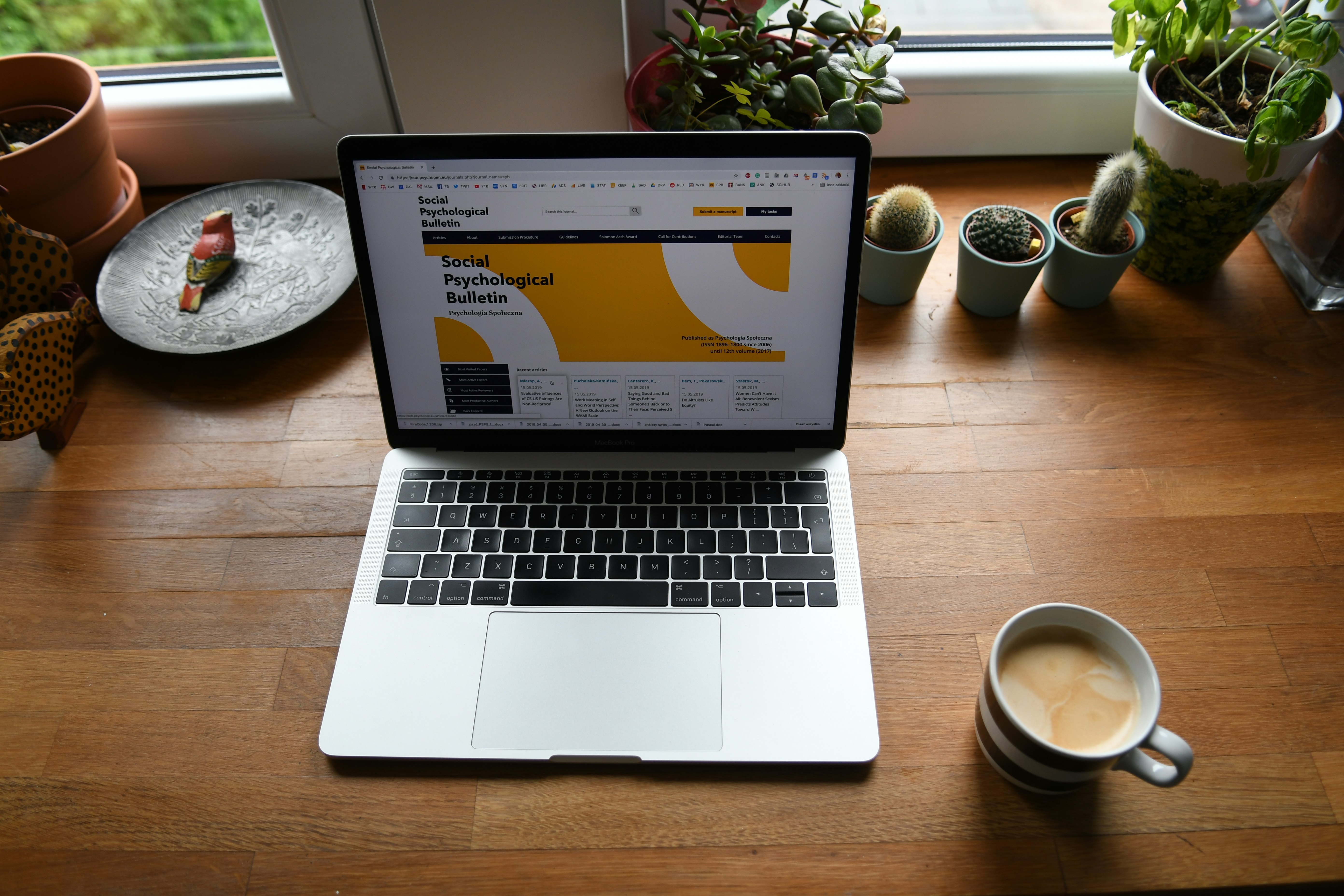 macbook pro on brown wooden table