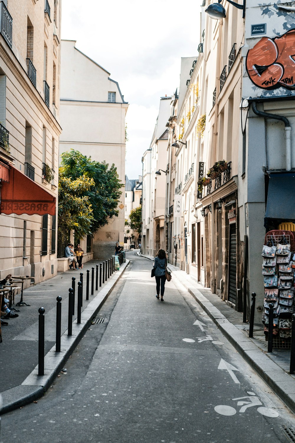 a person walking down a narrow city street