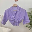 a purple shirt hanging on a clothes line