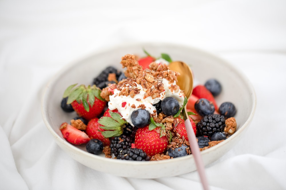 a bowl of fruit with a spoon in it