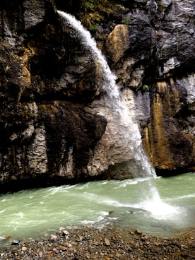 a man standing in front of a waterfall