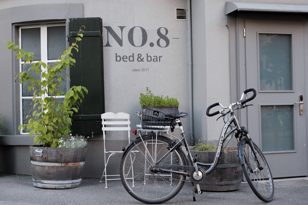 a bicycle parked next to a building with a no 8 bed and bar sign