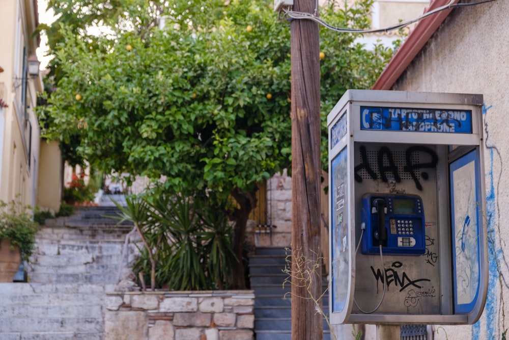 a phone booth with graffiti on the side of a building