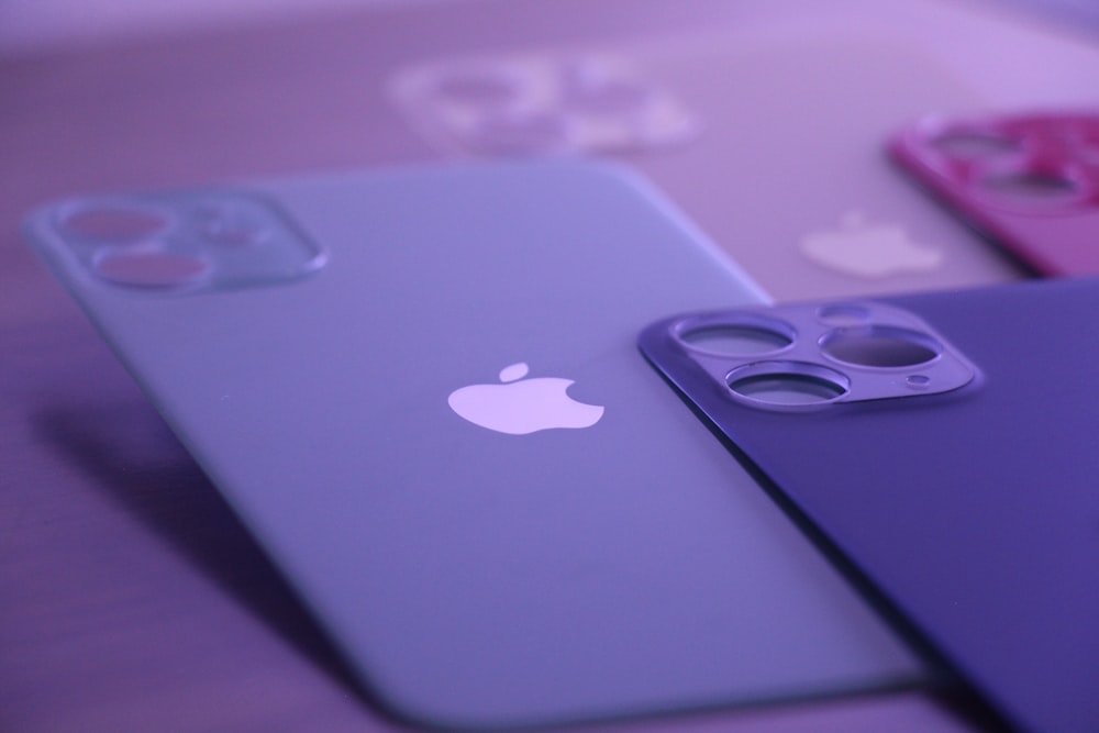 a close up of three cell phones on a table