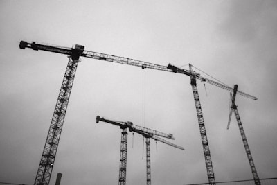 a group of cranes that are standing in the air