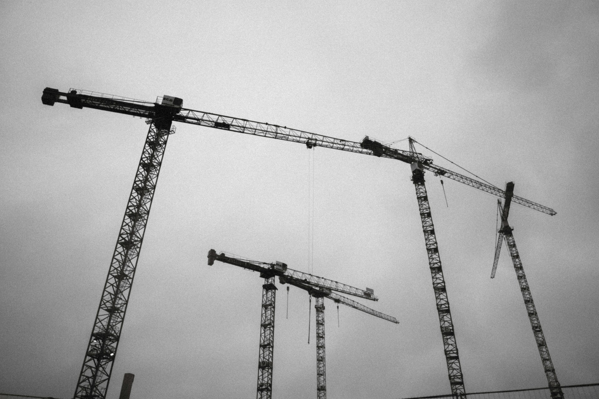 a group of cranes that are standing in the air