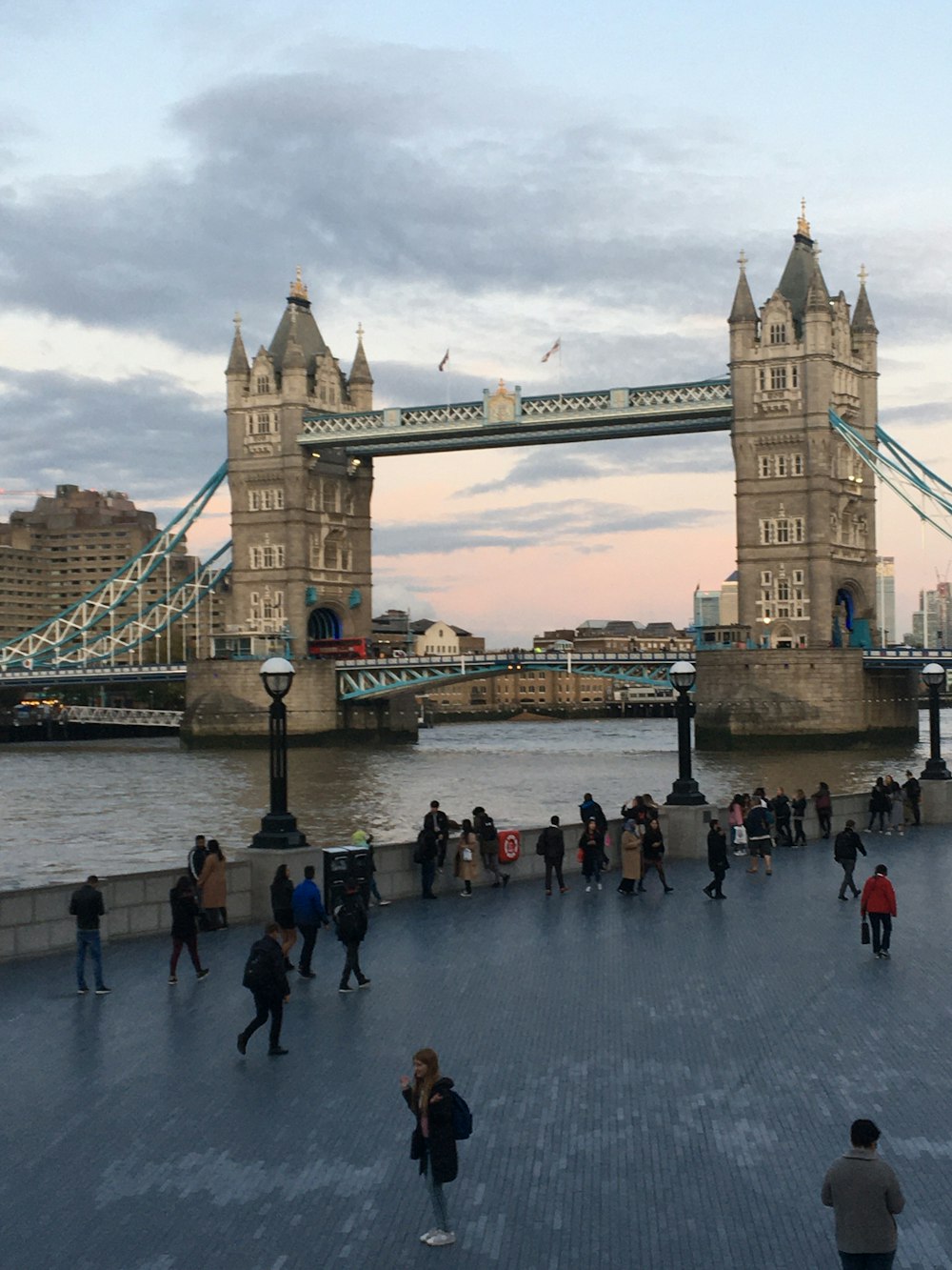 a group of people walking across a bridge