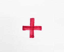 a red cross painted on a white paper