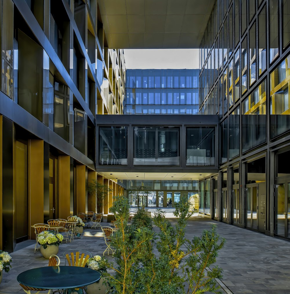 a courtyard with tables and chairs and plants