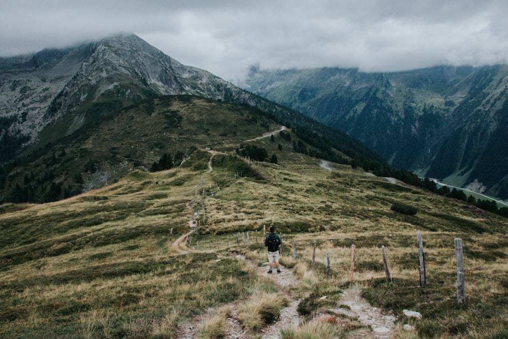 a person walking up a trail in the mountains