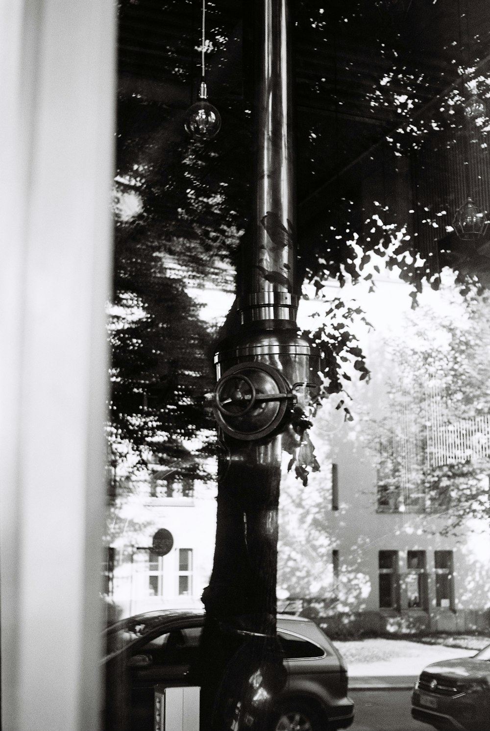 a black and white photo of a clock on a pole