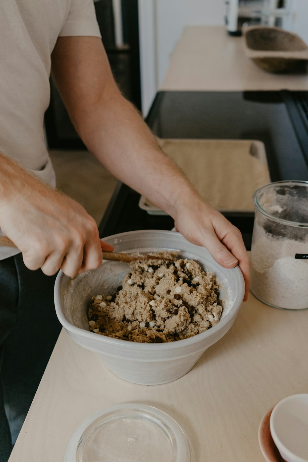 person holding stainless steel bowl with brown powder