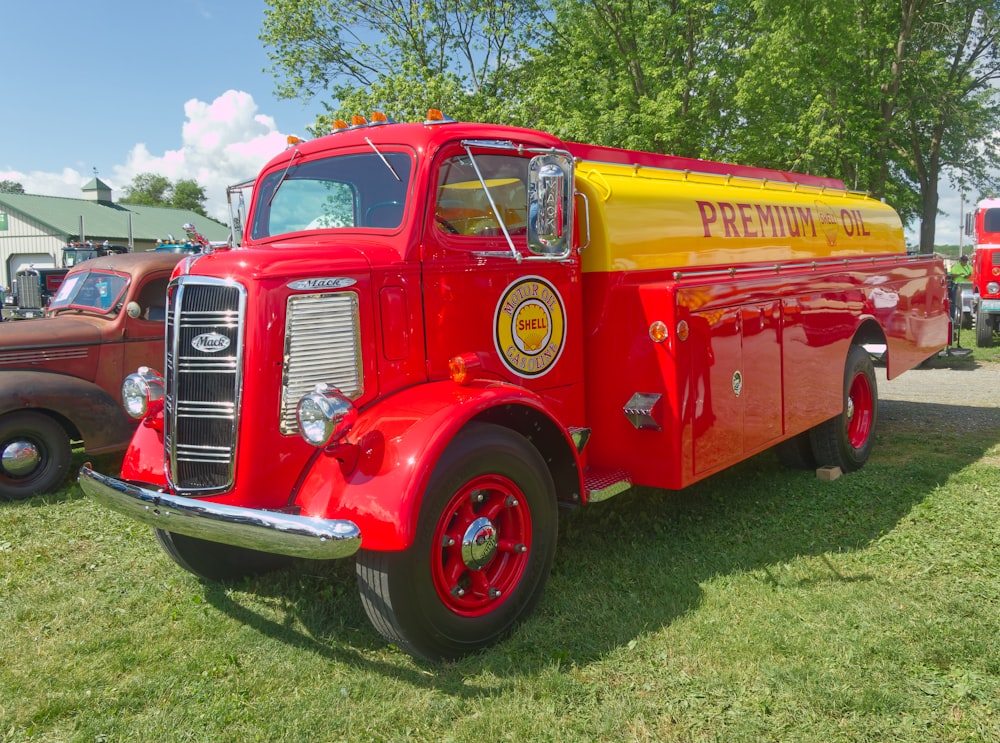 a red fire truck parked on top of a lush green field