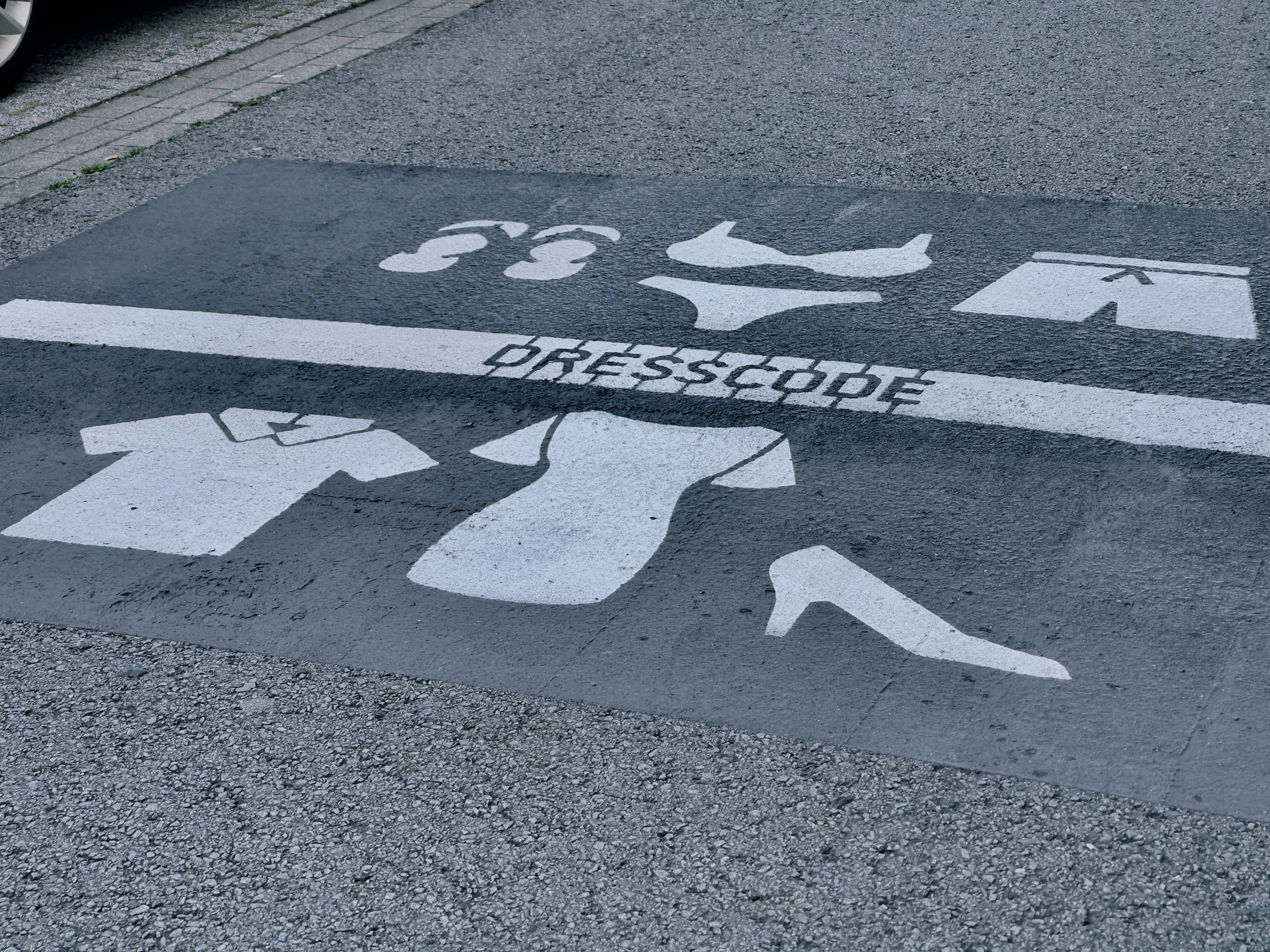 Dresscode sign on the streets. Depending on what side of the line you are, you should me dressed less naked.