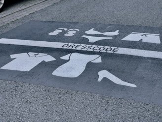 a parking space with a dress code painted on it